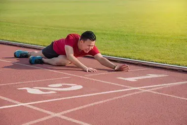 runner sitting on the ground after losing in competition - Half ...